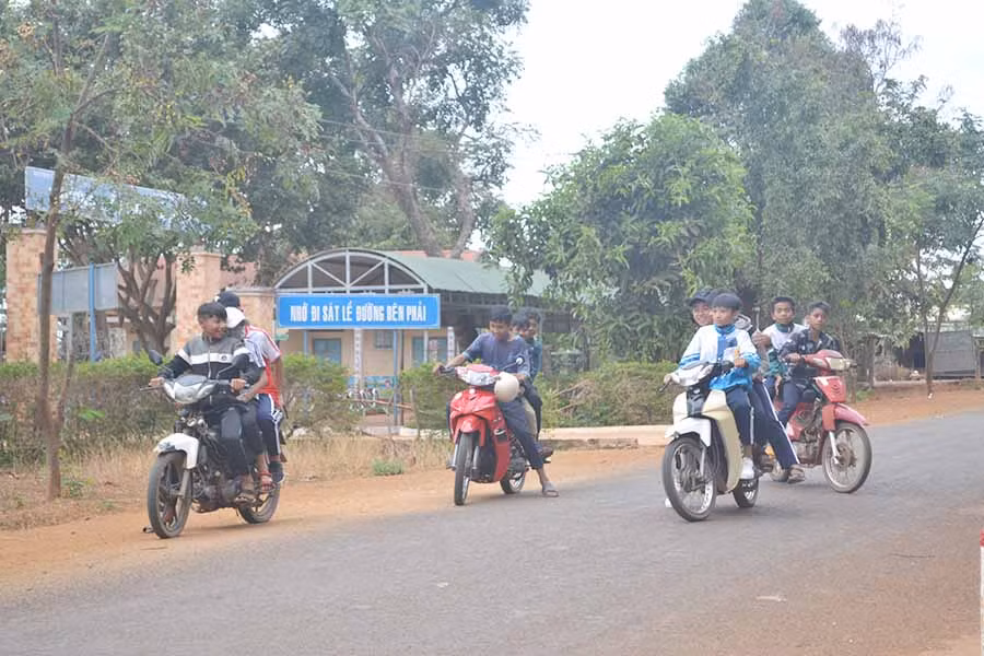  Nhiều thiếu niên điều khiển xe máy không đội mũ bảo hiểm, chở quá số người quy định trước cổng Trường THCS Ia Phí (huyện Chư Pah). Ảnh: H.C