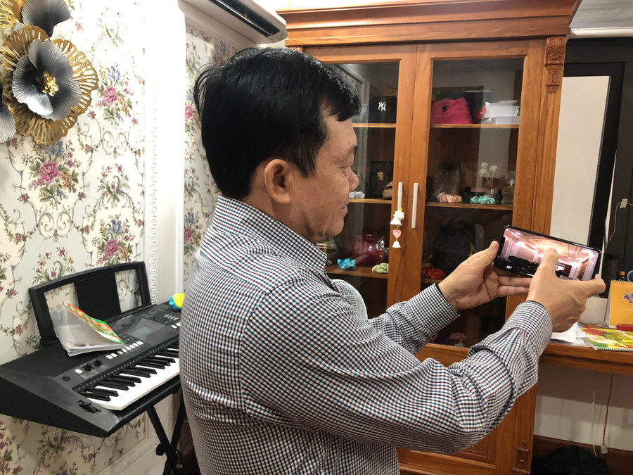 Anh Nguyễn Quốc Phong tắt mở các bóng đèn bằng Smart phone. Ảnh: Nguyễn Giang