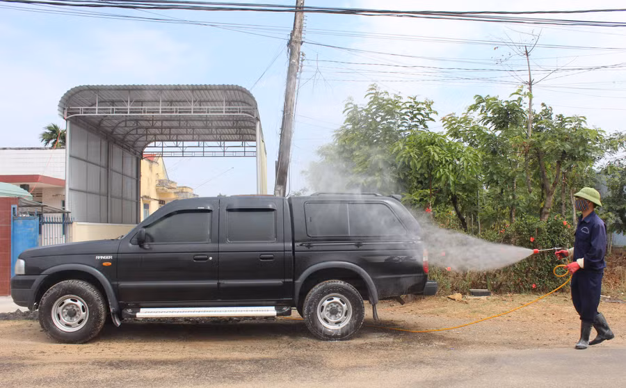 Tiêu độc, khử trùng các phương tiện ra vào các trại heo giống. Ảnh: Nguyễn Diệp 