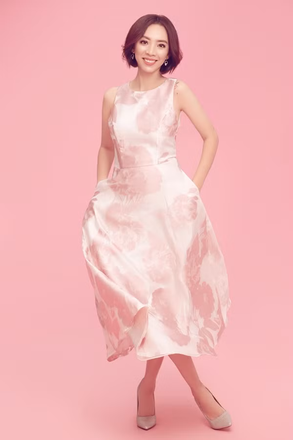 Váy lụa gam hồng ngọt ngào, phom dáng đơn giản, thích hợp diện đến công sở hoặc dạo phố cùng bạn bè.