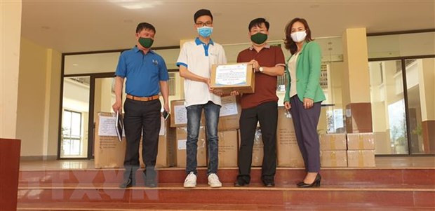 Lê Văn Phúc (áo trắng) trao hàng cho Bộ đội Biên phòng tỉnh Gia Lai hỗ trợ tuyến đầu phòng, chống dịch COVID-19. (Ảnh: TTXVN phát)