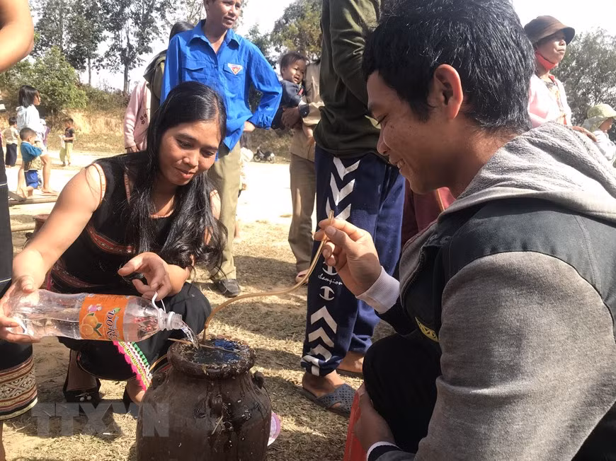 Người dân thưởng thức món rượu ghè tại Lễ hội. (Ảnh: Khoa Chương/TTXVN)