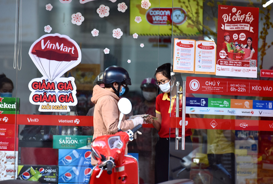 10/ Nhân viên và người mua hàng tại siêu thị Vinpmark đang trao đổi.