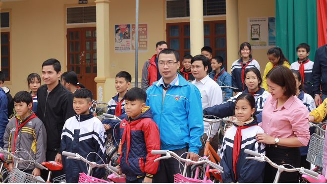 Thầy giáo Trương Văn Hùng (áo xanh) trong buổi trao tặng xe đạp - thành quả của thầy trò Trường cao đẳng kỹ thuật công nghệ Việt Nam - Hàn Quốc, cho học sinh nghèo. ẢNH NHẬT NAM