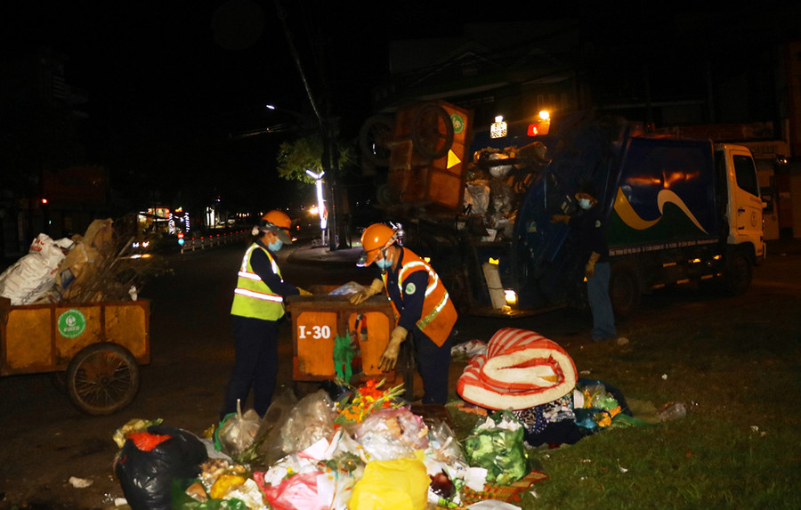  Các công nhân thu gom rác sạch sẽ và chất lên xe để chở về nơi xử lý. Ảnh: Hồng Thương