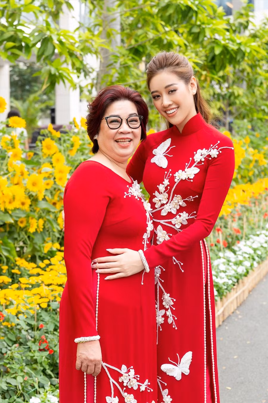 Hoa hậu Khánh Vân xúng xính diện áo dài đỏ cùng mẹ. Hiện cô vẫn đang tích cực chuẩn bị những kỹ năng để dự thi Miss Universe. Ảnh: NVCC.