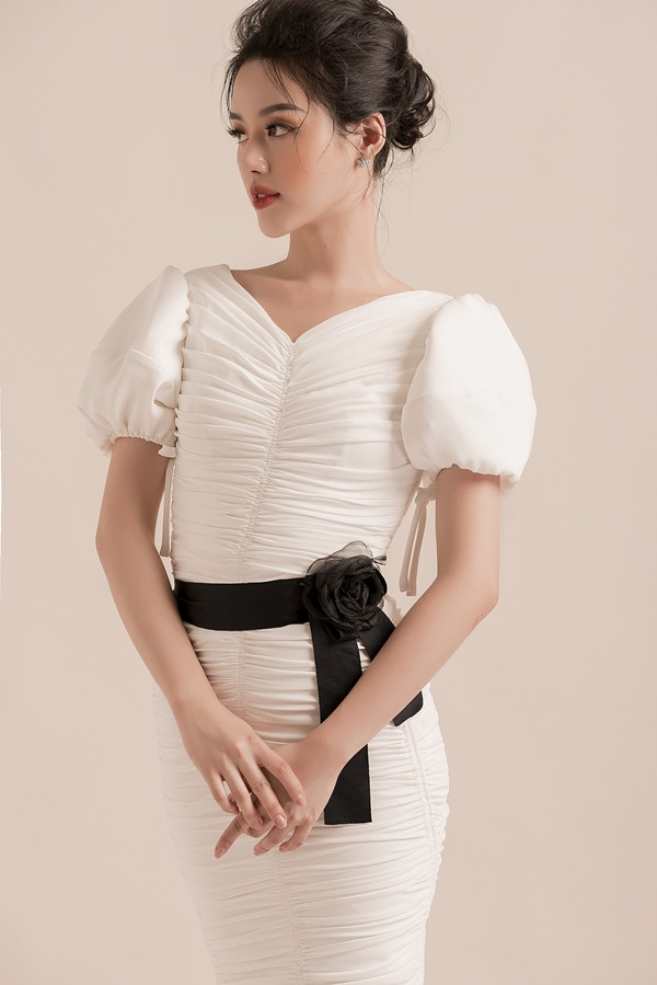 Khánh Linh thử nghiệm phong cách mới trong loạt váy ứng dụng, phù hợp công sở của nhà thiết kế Đỗ Long. Chi tiết xếp ly tinh tế kết hợp họa tiết to bản 3D tạo điểm nhấn nổi bật cho người mặc.