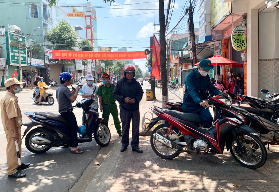 -Nhiều người dân còn chủ quan không đeo khẩu trang khi ra ngoài đường trong sáng 1-5 bị lực lượng chức năng lập biên bản. Ảnh: Như Nguyện 