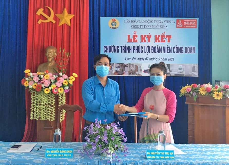 Lãnh đạo LĐLĐ thị xã Ayun Pa và Công ty TNHH Mười Xuân (bìa phải) ký kết thỏa thuận hợp tác chương trình phúc lợi cho đoàn viên và người lao động trên địa bàn thị xã. Ảnh: Nguyên Hương