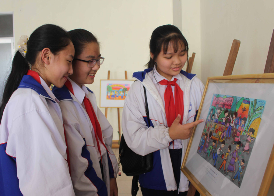 Các em học sinh tham quan tranh đạt giải Hội thi vẽ tranh “Em yêu Tổ quốc Việt Nam”. Ảnh: Thủy Bình