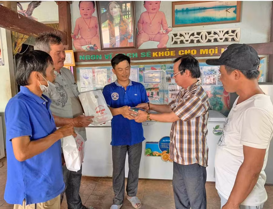 Ông Ngô Viết Giỏi-chủ cơ sở chả cá thác lác cô Sáu (thứ 2 từ phải qua, thôn Thanh Thượng, xã Ayun Hạ, huyện Phú Thiện) giới thiệu sản phẩm đến người tiêu dùng.Ảnh.Vũ Chi