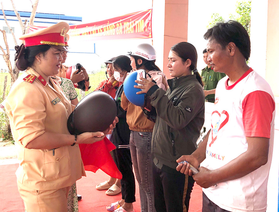 Lực lượng Cảnh sát Giao thông trao tặng mũ bảo hiểm cho người dân xã Ia Ake (huyện Phú Thiện). Ảnh: Lê Hòa