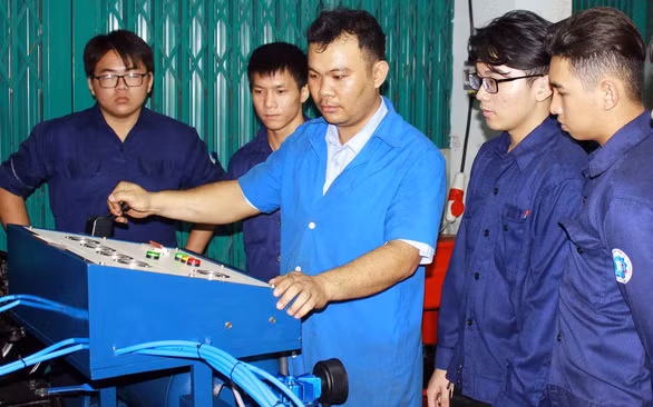 Bí thư - thầy giáo Nguyễn Quốc Đoàn (thứ ba, từ phải qua) hướng dẫn học sinh trong giờ thực hành - Ảnh: Q.L.