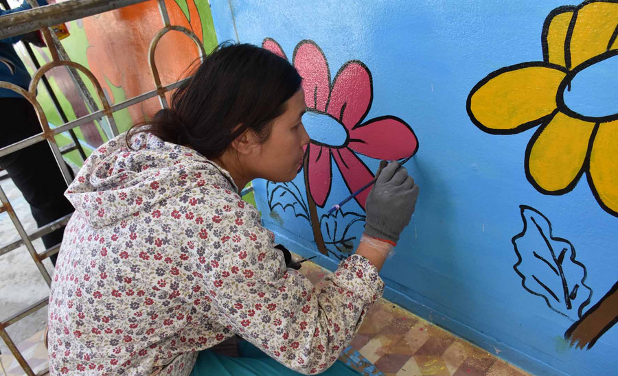 Những họa sỹ không chuyên tạo thêm vẻ đẹp thân thiện cho ngôi trường. Ảnh: Hà Phương