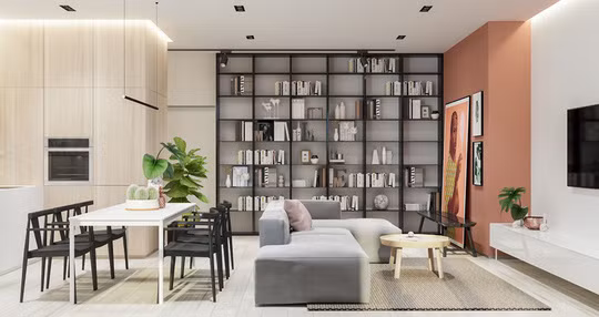 Giá sách đặt cạnh ghế sofa giúp tách biệt phòng khách và phòng ăn mà không cần dùng vách ngăn.