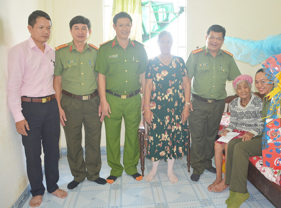  Đại tá Rah Lan Lâm-Bí thư Đảng ủy, Giám đốc Công an tỉnh thăm, tặng quà Mẹ Việt Nam Anh hùng Puih Krơn. Ảnh: Lê Ánh