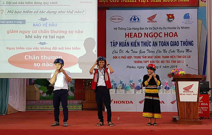  Các bạn học sinh thực hành đội mũ bảo hiểm đúng cách. Ảnh: H.Đ.T