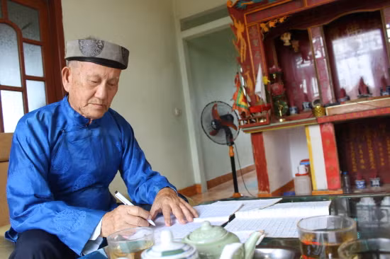 Nghệ nhân Ưu tú Phạm Văn Pẩu biên soạn lại các bài hát đối cổ. Ảnh: Long Vũ Nghệ nhân Ưu tú Phạm Văn Pẩu biên soạn lại các bài hát đối cổ. Ảnh: Long Vũ