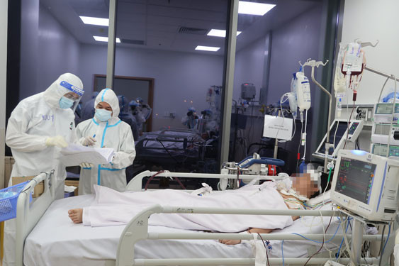 BS Trần Thanh Linh ( đứng thứ hai từ trái sang) kiểm tra hồ sơ bệnh nhân. Ảnh: Phạm Dũng