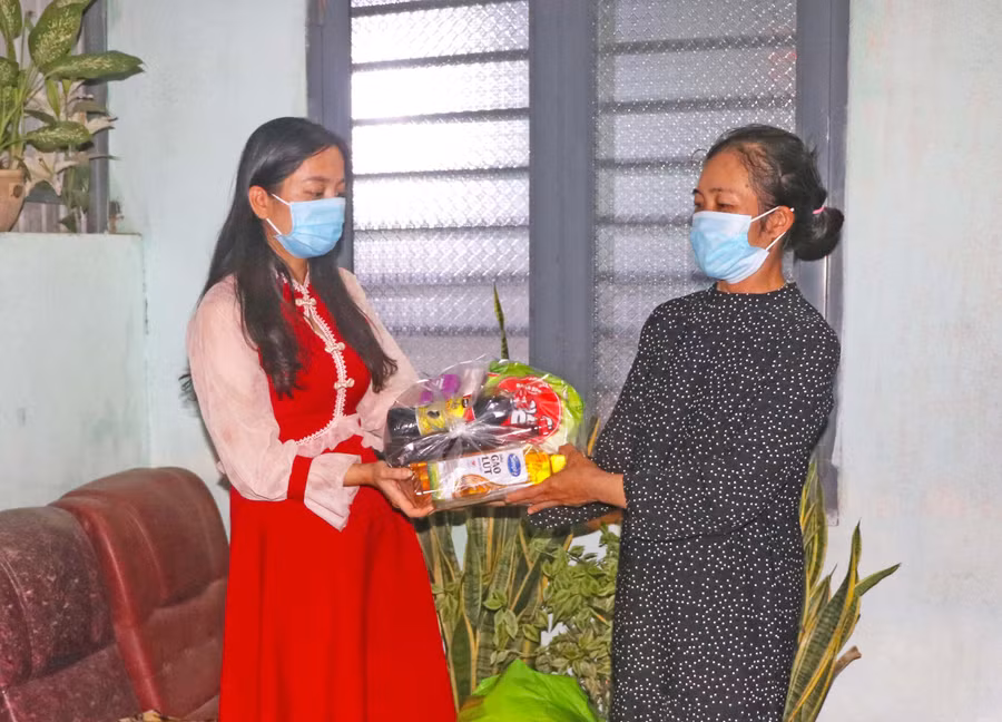 Chị Phạm Thị Thu Thủy (bìa trái) tặng quà cho hội viên gặp khó khăn bởi dịch Covid-19. Ảnh: Ngọc Minh