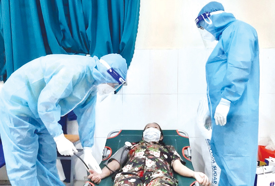 Các y-bác sĩ Gia Lai thăm khám cho một bệnh nhân tại Khu cách ly 122 Hòa Bình, phường Tân Thới Hòa, quận Tân Phú, TP. Hồ Chí Minh (ảnh đoàn công tác cung cấp).