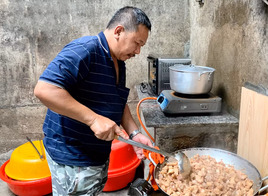 Ông Đỗ Ngọc Bình nấu cơm chiều cho bệnh nhân tại Bệnh viện dã chiến số 3. Ảnh: Như Nguyện