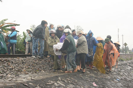 Thừa Thiên- Huế: Tai nạn tàu hỏa gây chết người ảnh 2 Bà con làng xóm chung quanh giúp chuyển thi thể nạn nhân ra khỏi hiện trường