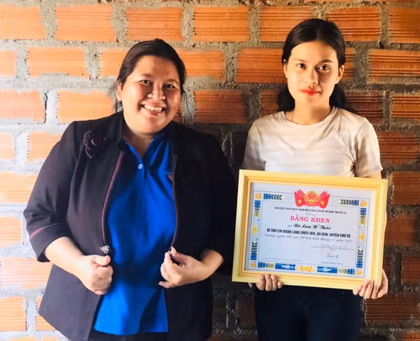 Chị Hà Thị Giang Thảo-Phó Bí thư Tỉnh Đoàn tặng bằng khen của Ban Chấp hành Tỉnh Đoàn cho chị Rơ Lan H'Thảo. Ảnh: T.B