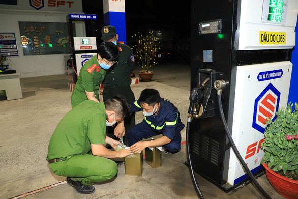 Lực lượng chức năng niêm phong, lấy mẫu tại một cây xăng liên quan vụ án.  Lực lượng chức năng niêm phong, lấy mẫu tại một cây xăng liên quan vụ án