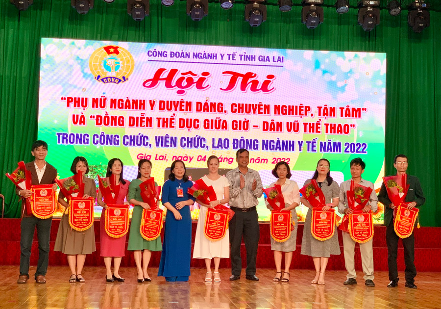 Ông Đinh Hà Nam (thứ 5 từ phải qua)-Phó Giám đốc Sở Y tế và bà Nguyễn Thị Ánh Xuân (thứ 5 từ trái qua)- Chủ tịch Công đoàn ngành Y tế Gia Lai trao hoa và cờ lưu niệm cho các đơn vị tham gia hội thi. Ảnh: Như Nguyện Ông Đinh Hà Nam (thứ 5 từ phải qua)- Phó Giám đốc Sở Y tế tỉnh và bà Nguyễn Thị Ánh Xuân (thứ 5 từ trái qua)- Chủ tịch Công đoàn ngành Y tế Gia Lai trao hoa và cơ lưu niệm cho các đơn vị tham gia hội thi. Ảnh: Như Nguyện