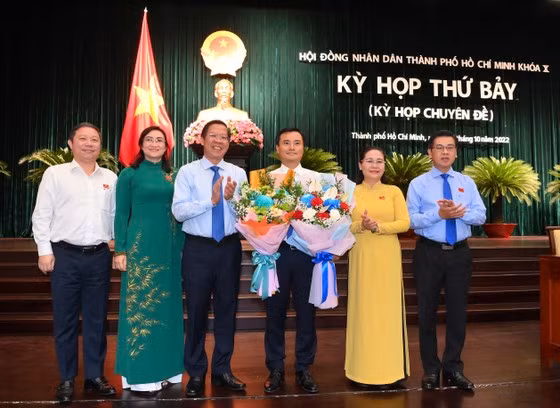 Các đồng chí lãnh đạo TPHCM tặng hoa chúc mừng đồng chí Bùi Xuân Cường. Ảnh: VIỆT DŨNG