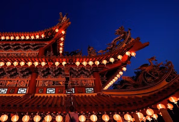 Một công nhân đang sửa lại những lồng đèn đỏ trang trí ở chùa Thean Hou, Malaysia, trước đêm giao thừa.