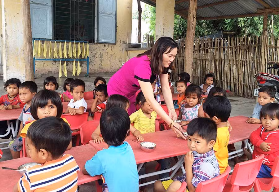  Cô Hoàng Thị Bảy chăm sóc học sinh trong một giờ ăn trưa. Ảnh: Như Loan