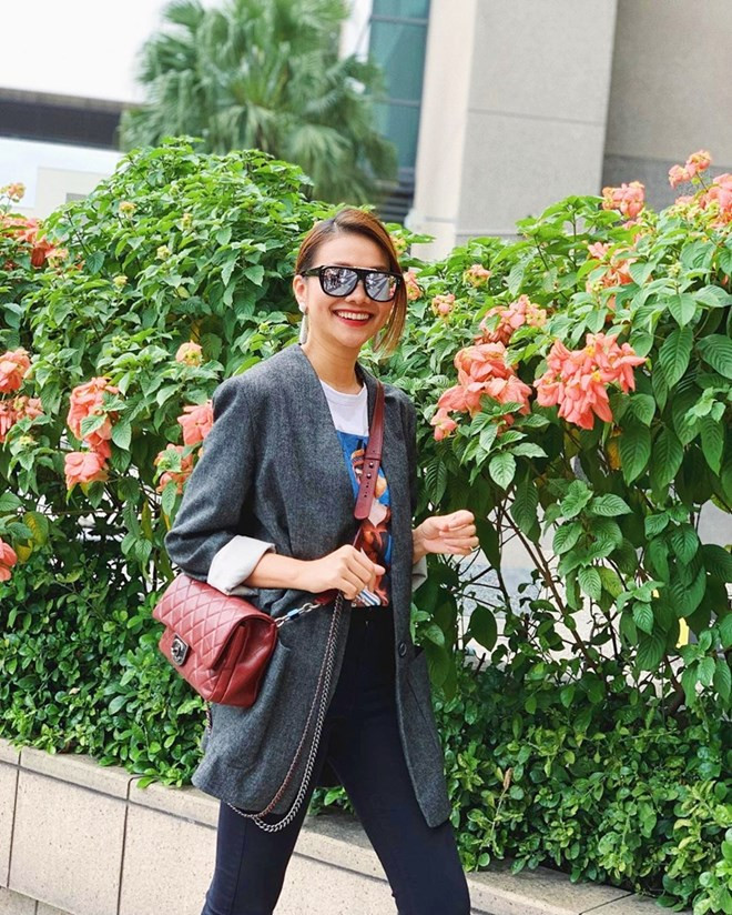  Trẻ trung với áo phông và quần jeans, Thanh Hằng không quên phủ lớp áo khoác ngoài để tăng vẻ mạnh mẽ. Chiếc túi Chanel màu đỏ rượu là phụ kiện giúp set đồ của siêu mẫu thêm bắt mắt.