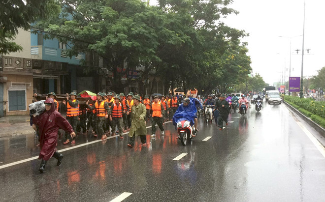  Lực lượng cứu hộ đưa thi thể vợ anh Việt về nhà. Ảnh: T.H.