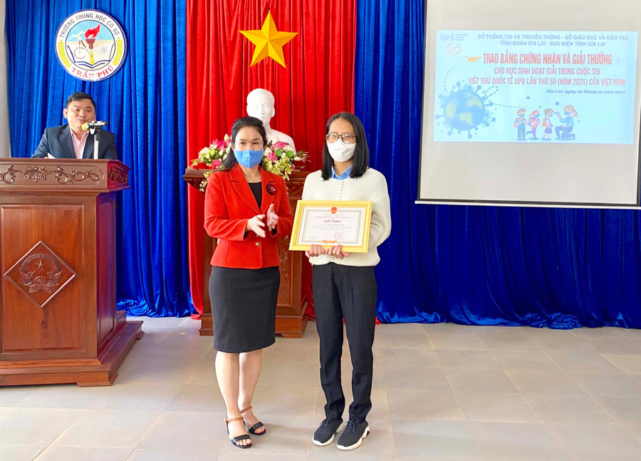 Bà Bùi Khoa Nghi-Phó Giám đốc Sở GD-ĐT trao thưởng cho học sinh duy nhất của Gia Lai đạt giải tại Cuộc thi Viết thư Quốc tế UPU lần thứ 50 năm 2021. Ảnh: Mộc Trà.