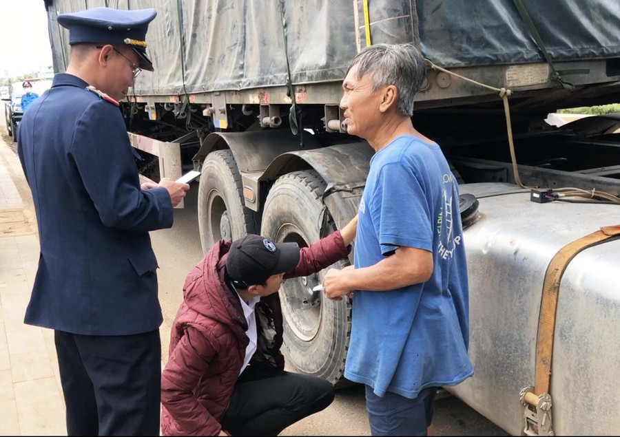 Thanh tra Sở GT-VT đo kích thước thành thùng một phương tiện vận tải hàng hóa. Ảnh: Lê Hòa