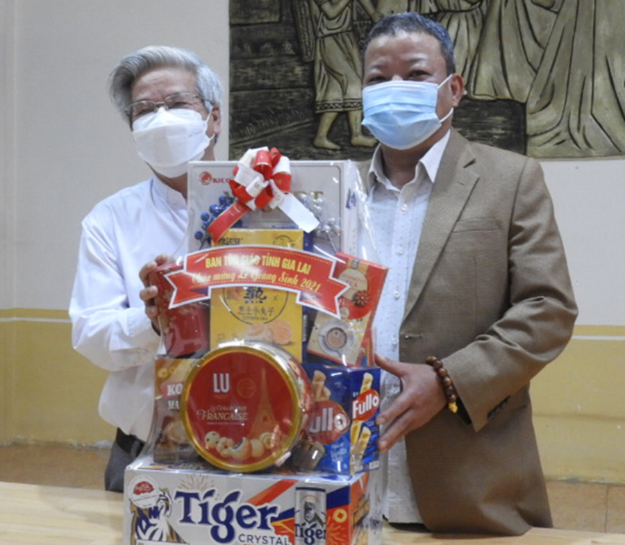 Trưởng Ban Tôn giáo tỉnh Hồ Hải Tần (bìa phải) tặng quà giáng sinh tại Giáo xứ Thăng Thiên (phường Tây Sơn, TP. Pleiku). Ảnh: Thanh Nhật (0272). 
