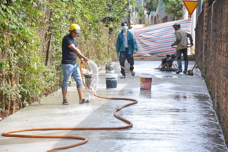  Thi công đường bê tông xi măng tại thôn 1, thị trấn Phú Hòa. Ảnh: Hoàng Cư