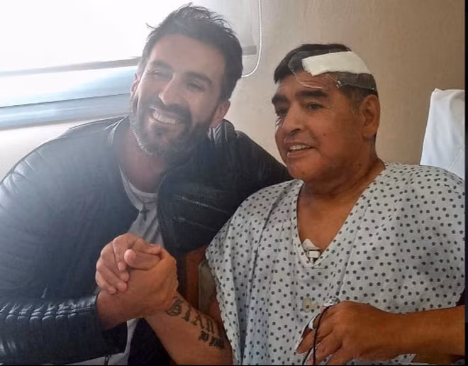 Diego Maradona và bác sĩ Leopoldo Luque sau cuộc phẫu thuật để loại bỏ cục máu đông trong não - Ảnh: Chụp màn hình