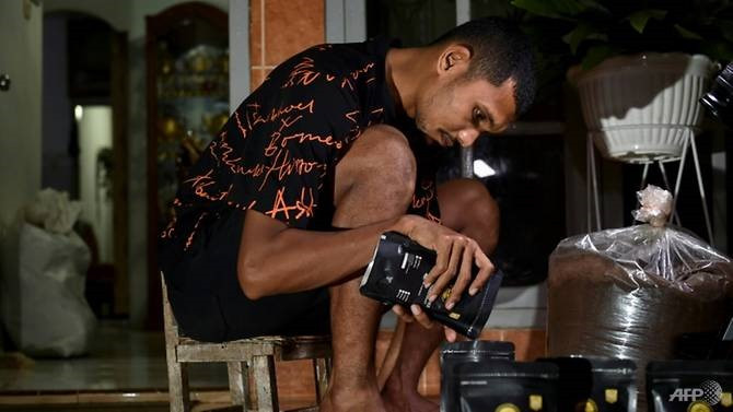 Andri Muliadi phải phụ vợ bán cà phê trong giai đoạn giải Indonesia nghỉ vì dịch COVID-19. Ảnh: AFP.