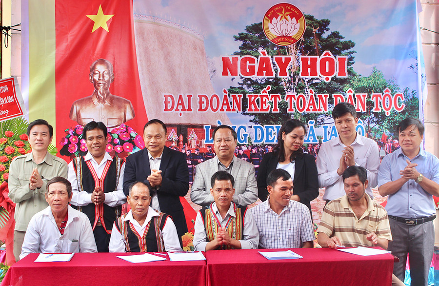 Đại diện 5 gia đình tiêu biểu của làng Del ký kết giao ước thi đua trước sự chứng kiến của các đại biểu. Ảnh Phan Lài