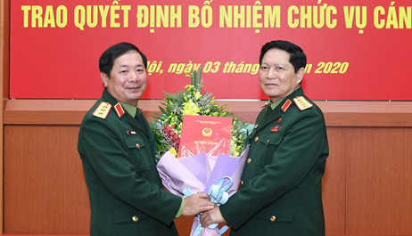 2 tân Thứ trưởng Bộ Quốc phòng nhận quyết định bổ nhiệm ảnh 1 Đại tướng Ngô Xuân Lịch trao quyết định và tặng hoa chúc mừng Thượng tướng Lê Huy Vịnh.