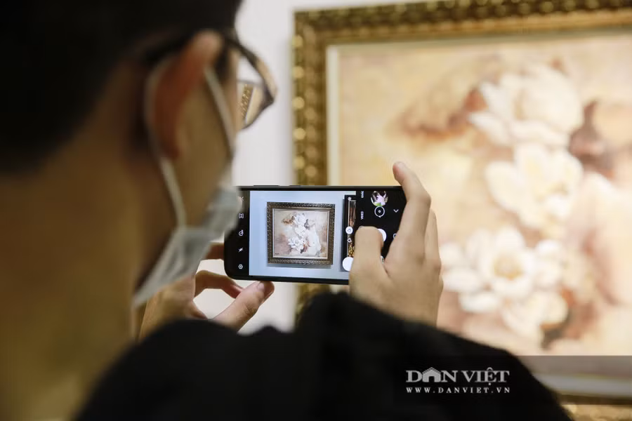  Nhiều người thích thú dùng điện thoại chụp hình lưu lại các bức tranh.