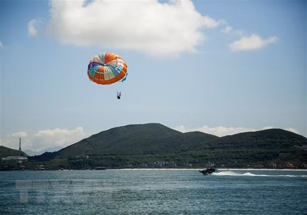 Dù bay, môn thể thao hấp dẫn cho du khách trên bãi biển Hòn Tằm, Nha Trang. Ảnh: Hồng Đạt/TTXVN