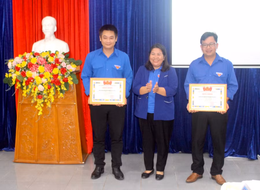 Chị Hà Thị Giang Thảo (ở giữa)-Bí thư Tỉnh Đoàn tặng bằng khen cho 2 tập thể có thành tích xuất sắc trong triển khai giới thiệu, tuyên dương gương người tốt-việc tốt giai đoạn 2018-2022. Ảnh: Phan Lài