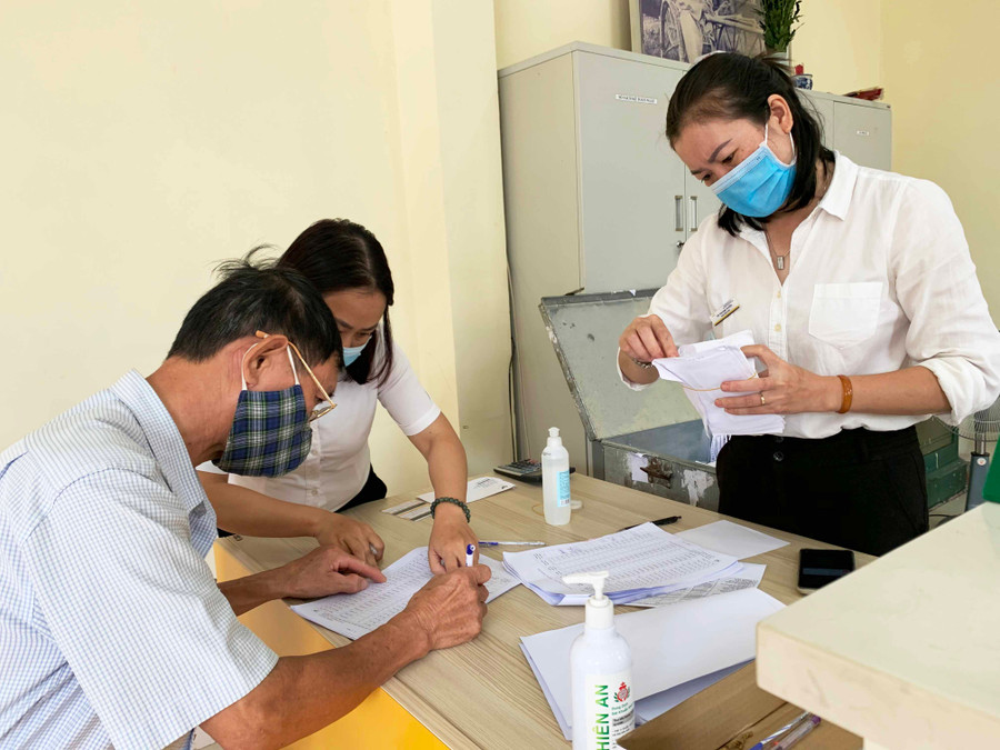 Điểm chi trả lương hưu, BHXH phường Yên Đỗ, TP.Pleiku thực hiện nghiêm các quy định phòng chống dịch. Ảnh: Như Nguyện