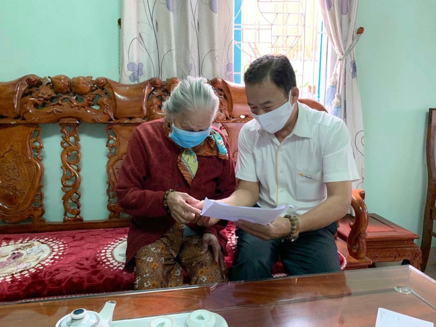 Nhân viên Bưu điện tỉnh chi trả lương hưu và trợ cấp BHXH tại nhà cho bà Phạm Thị Khái (266 Hai Bà Trưng, TP. Pleiku). Ảnh: Như Nguyện 