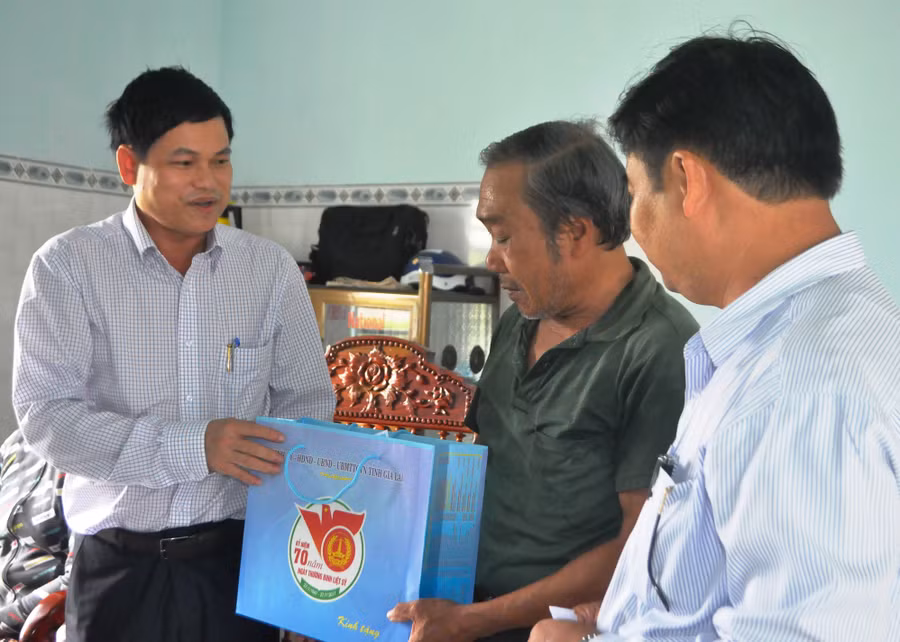 Đồng chí Trưởng ban Tổ chức Tỉnh ủy trao quà cho gia đình chính sách. Ảnh: Trần Dung