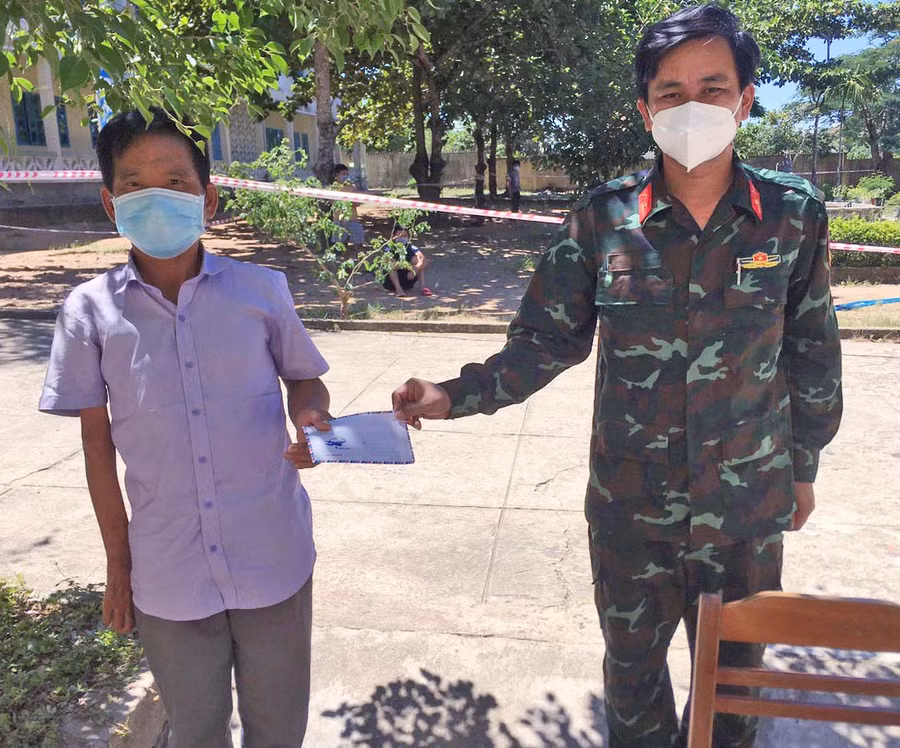 Cán bộ khu cách ly tập trung huyện Kbang trao quà hỗ trợ người nghèo thực hiện cách ly tại đây . Ảnh: Lam Nguyên